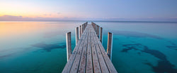 Photograph of a jetty in Dunsborough, Australia at sunset. 