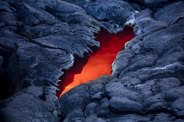 Hawaiian Landscape Photography by Lijah Hanley. A River of Kilauea Lava is visible through a crack on the Big Island of Hawaii. 