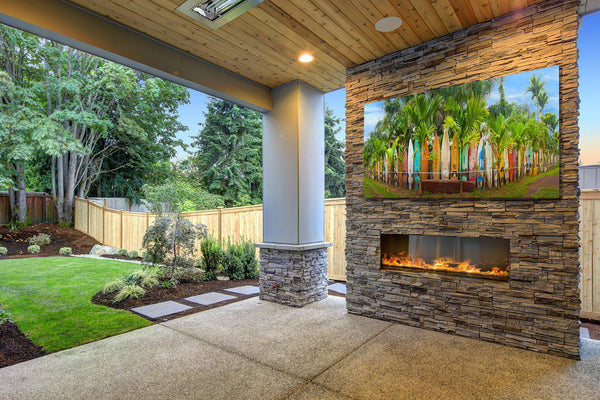 Hawaiian print of surfboards hangs above a fireplace. 