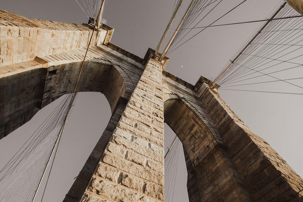 Looking up at the archways of the Brooklyn Bridge in New York