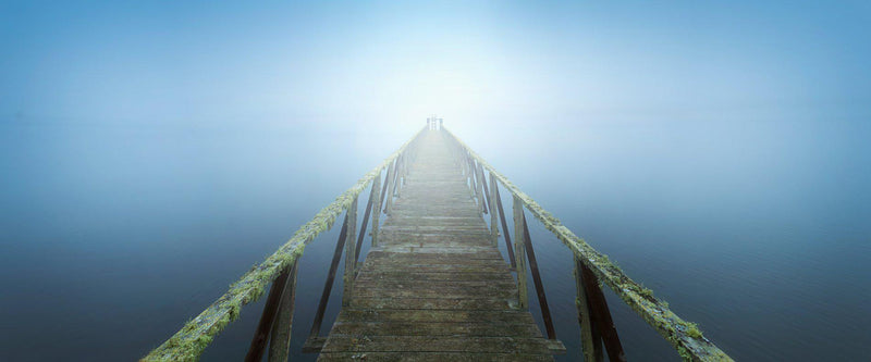 Pier going into fog on the California coast. 