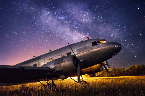 Fine art aviation photography of a DC-3 airplane against the night sky. 