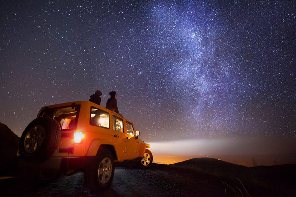 a Jeep sits under the stars