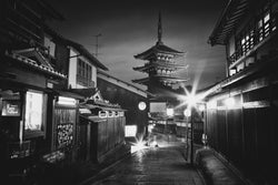 A pagoda viewed from the streets of Kyoto at night