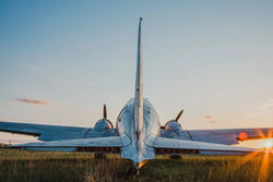 The back of a dc-3 or c-47 plane at sunset. 