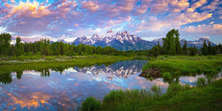 The Grand Teton mountains reflecting in a river at sunrise. By Lijah Hanley. 