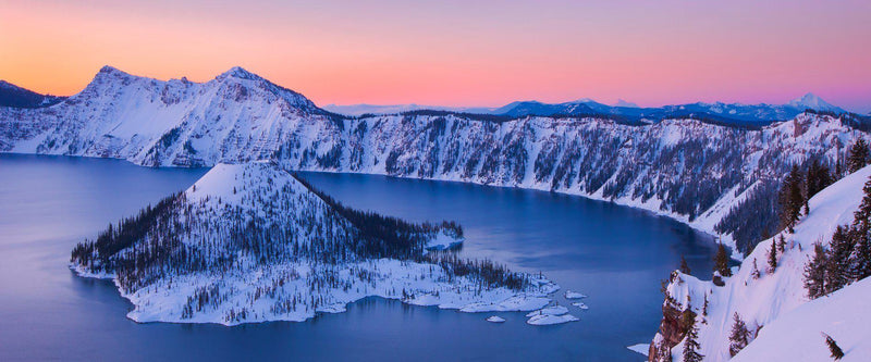 Photograph of wizard island in Crater Lake, Oregon at sunrise. 